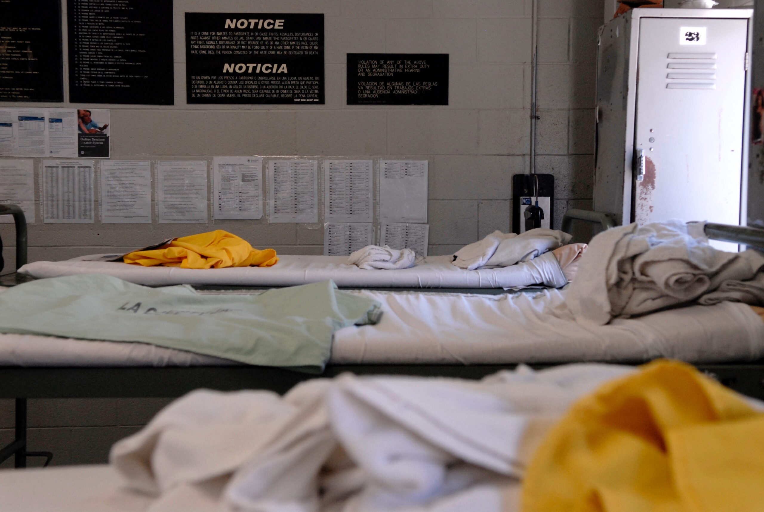 Empty bed in a detention center facility, reflecting the human realities of immigration detention and calls for accountability.